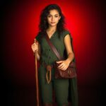 Madrika concept art of a girl in green with a brown bag.